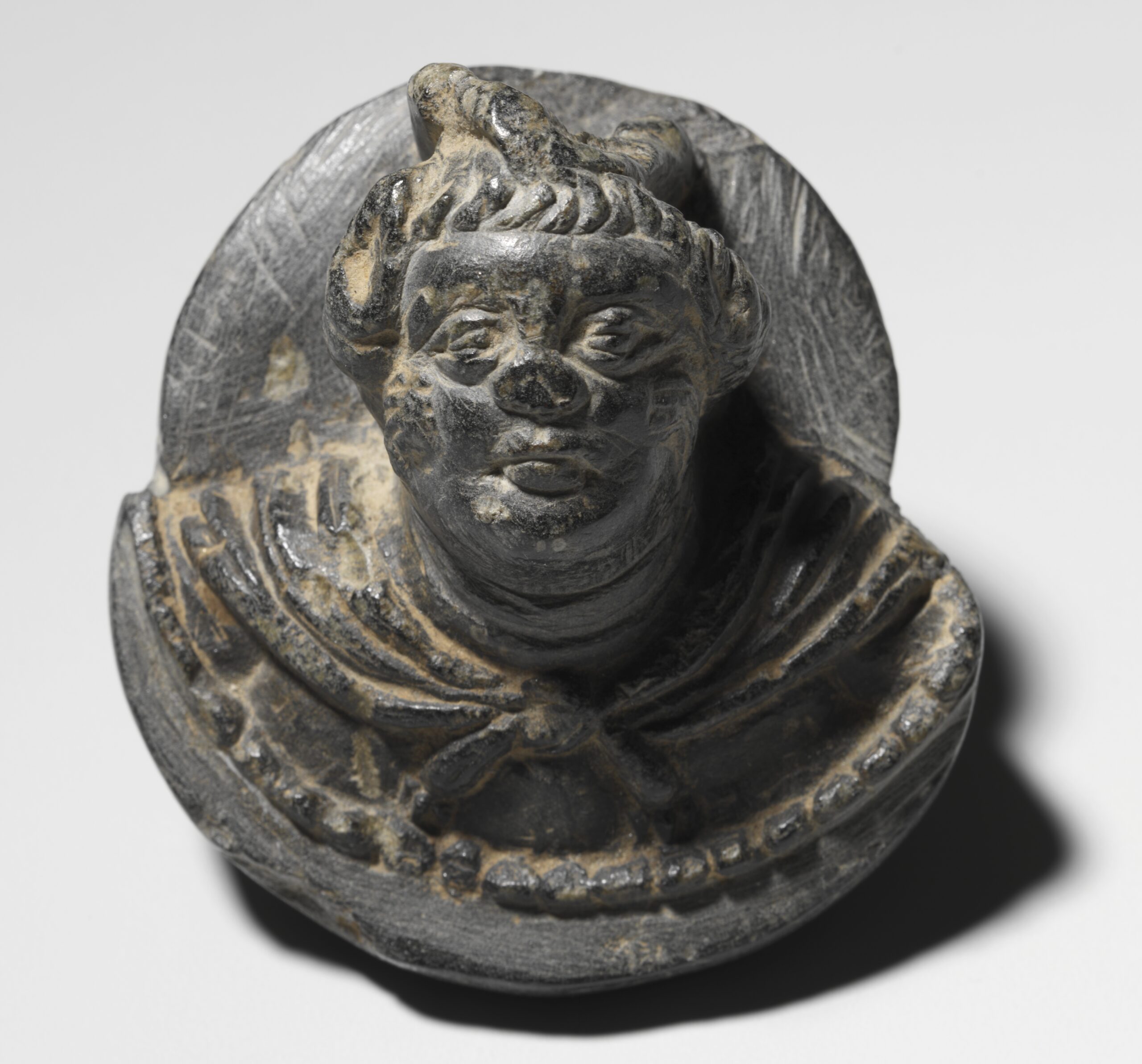 Plaque with a Male Head, gandhara, 100s CE