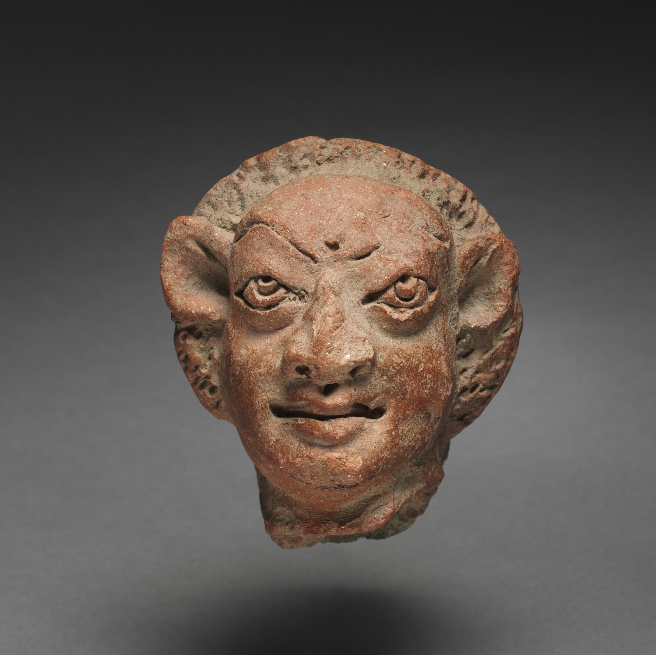 Grotesque Male Head, terracotta, c. 400