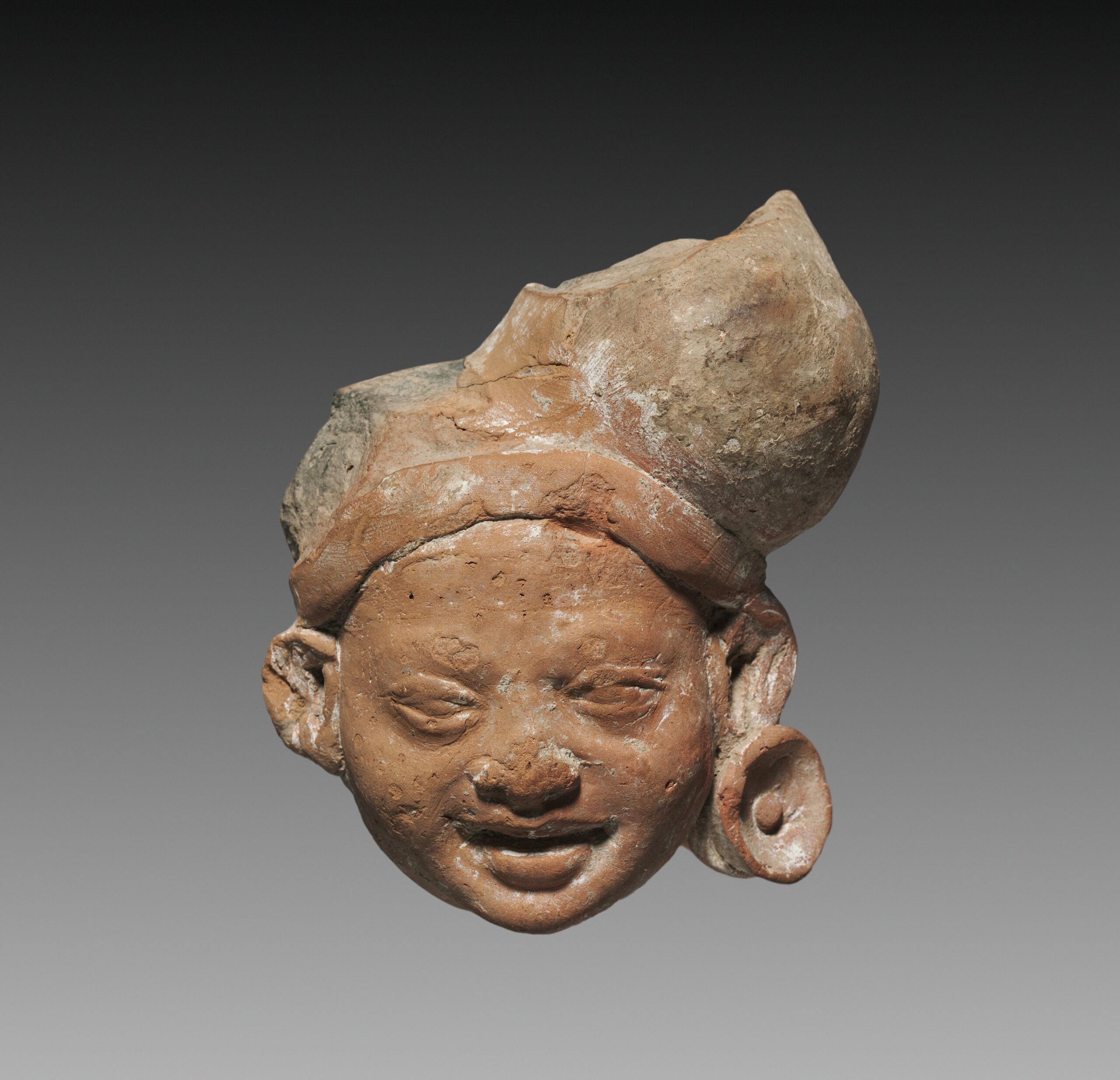 Male Head, possibly a Yaksha, terracotta, 300s BCE
