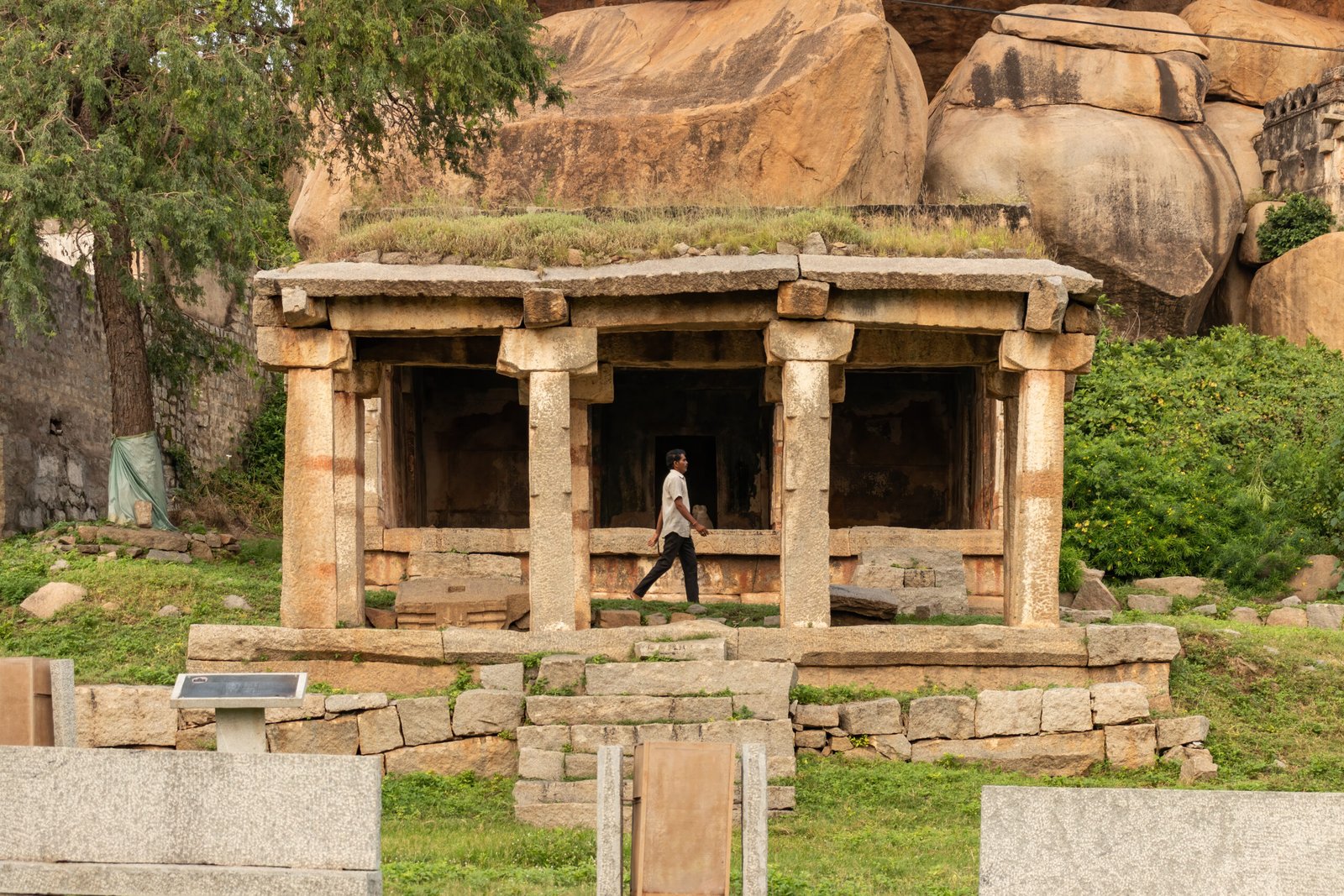Man walking infront of Harihara temple, Hemakunta hill, vijayanagara